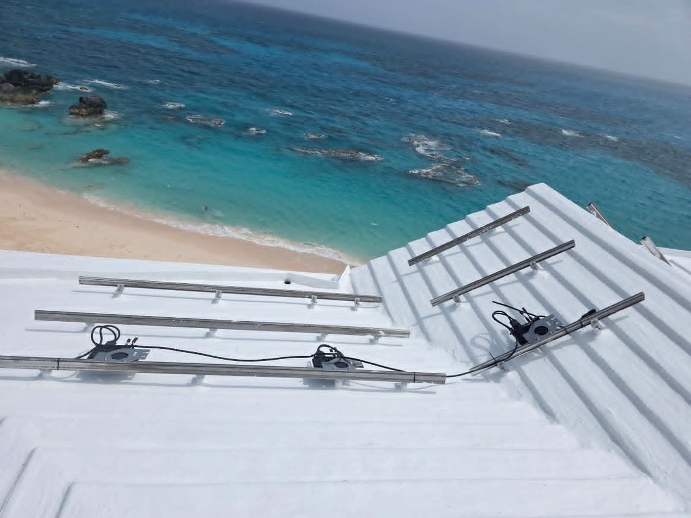 Solar rails and microinverters in place on a roof with the panels removed