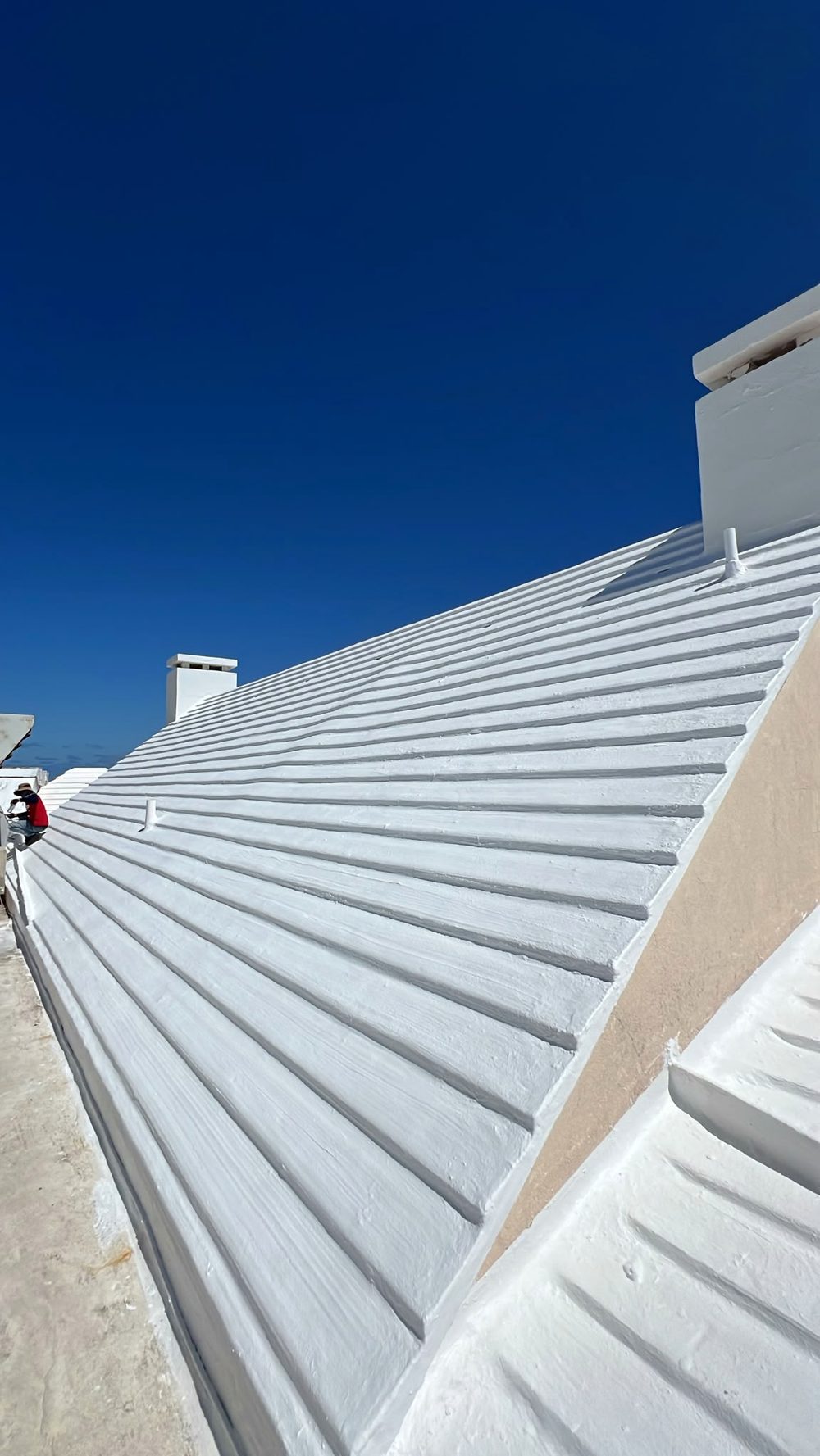 A freshly coated white roof under the solar rails